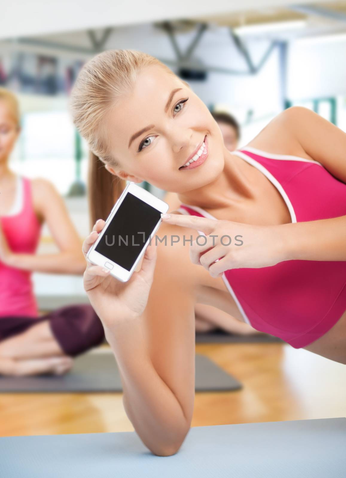 fitness, sport, training, gym and lifestyle concept - woman lying on the floor and sowing smartphone