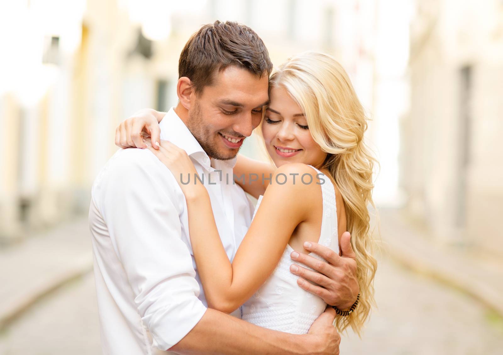 romantic happy couple hugging in the street by dolgachov