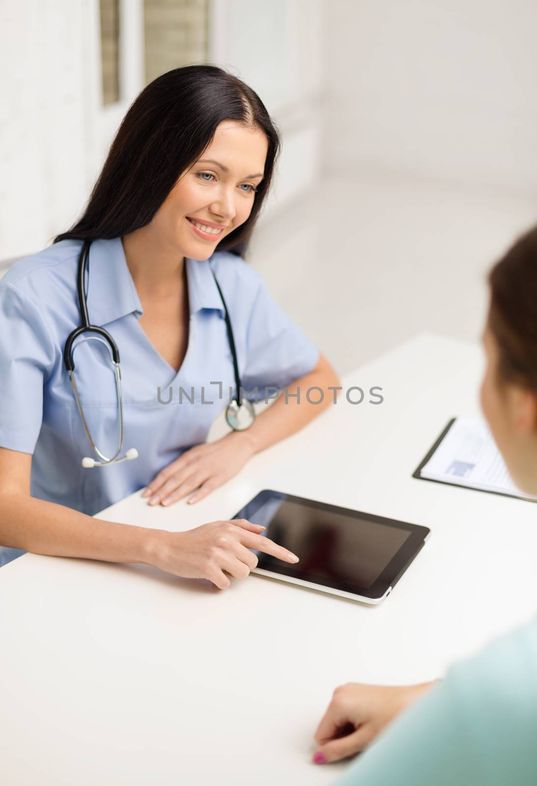 female doctor or nurse with tablet pc computer by dolgachov