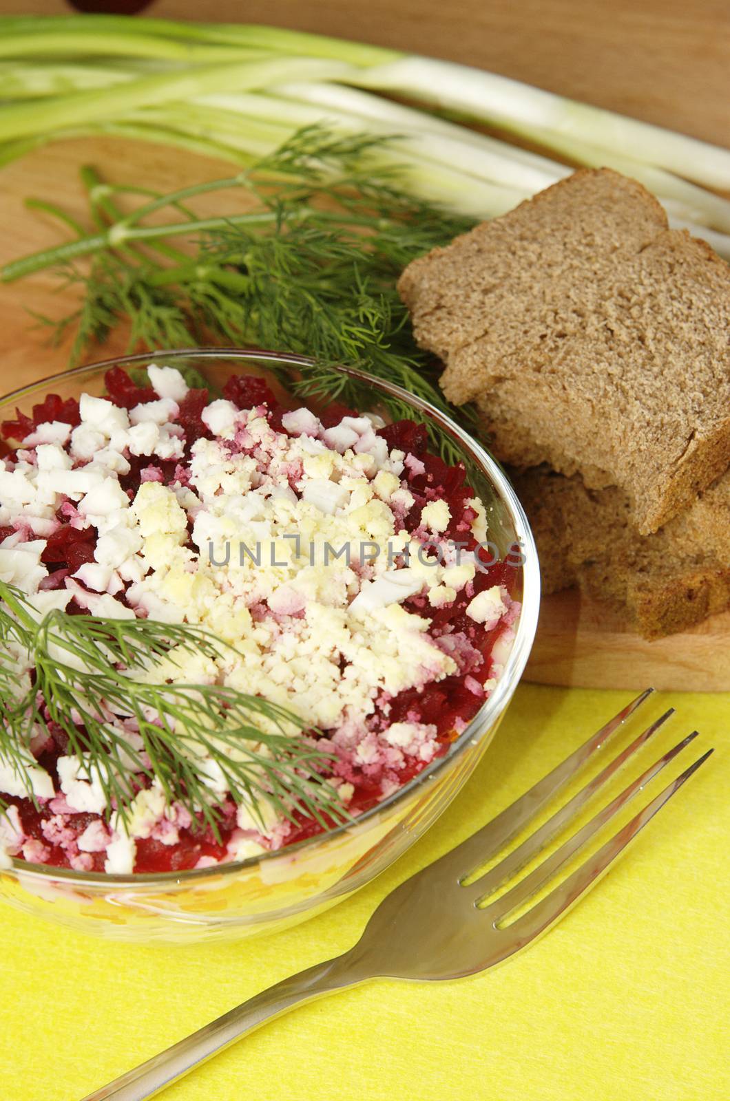 Russian traditional herring salad in glass bowl