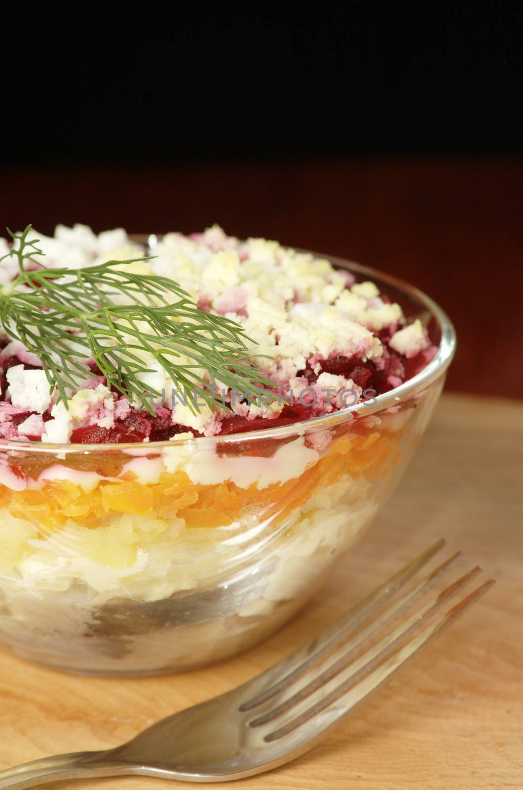 Russian traditional herring salad in glass bowl