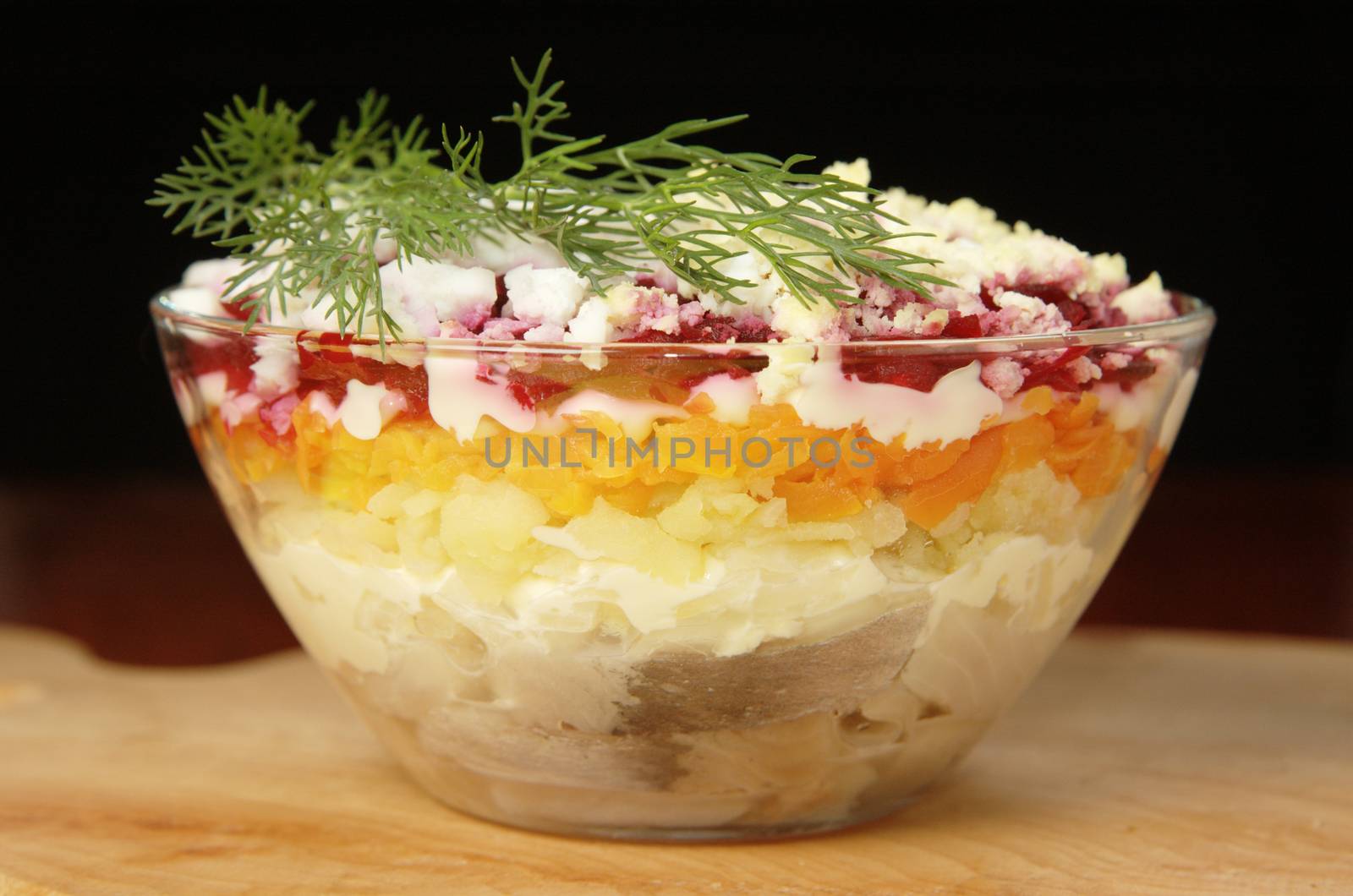 Russian traditional herring salad in glass bowl