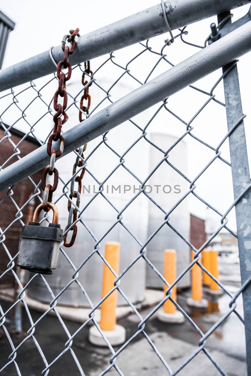 Gray fence and Rusty Hanging Lock Concept