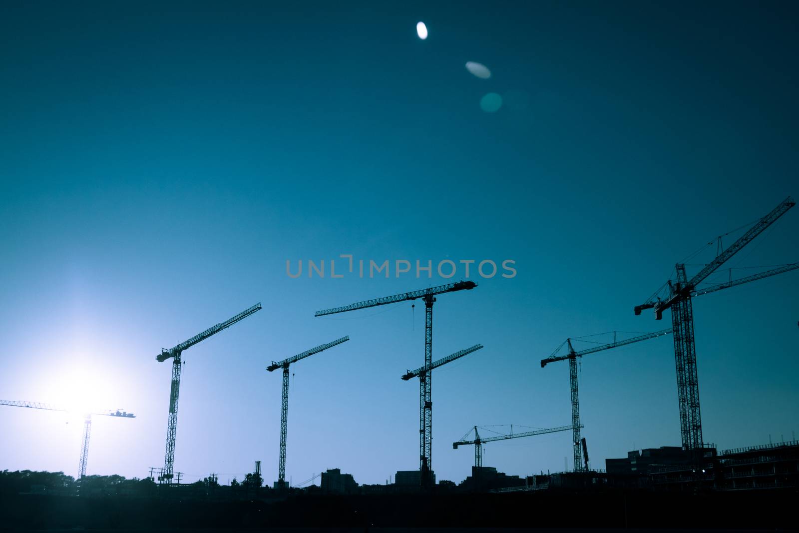 Crane Silhouette of a big Construction Site by aetb