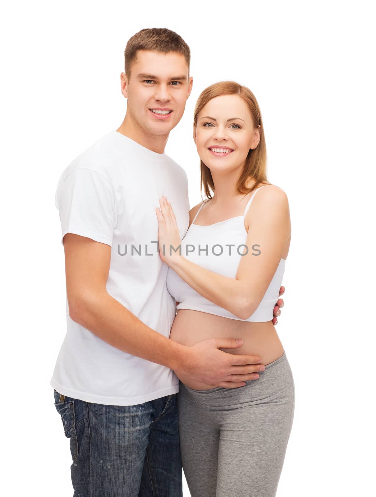 happy young family expecting child by dolgachov