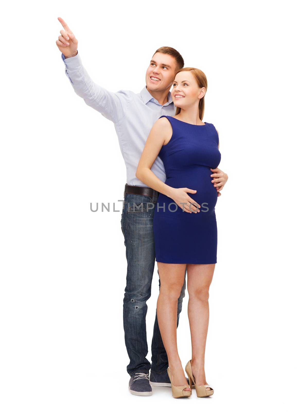 happy young family expecting child pointing finger by dolgachov