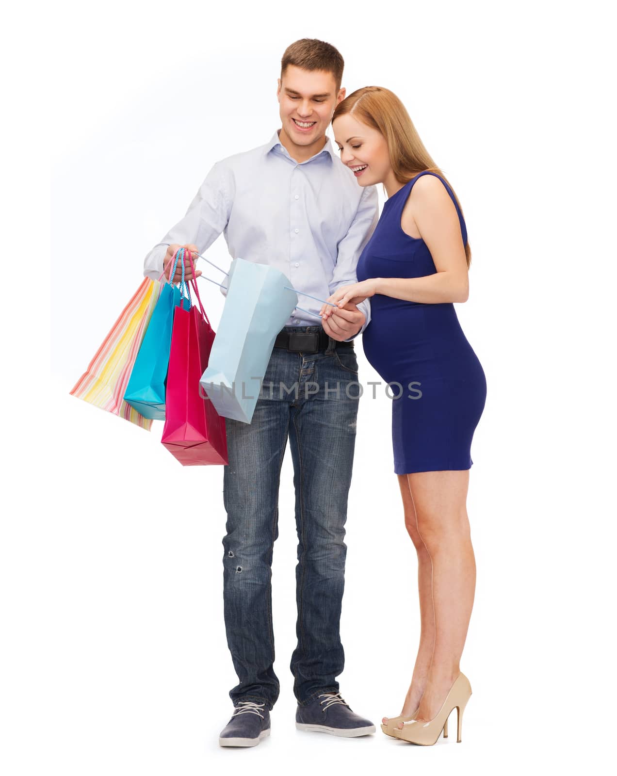 happy family expecting child with shopping bags by dolgachov