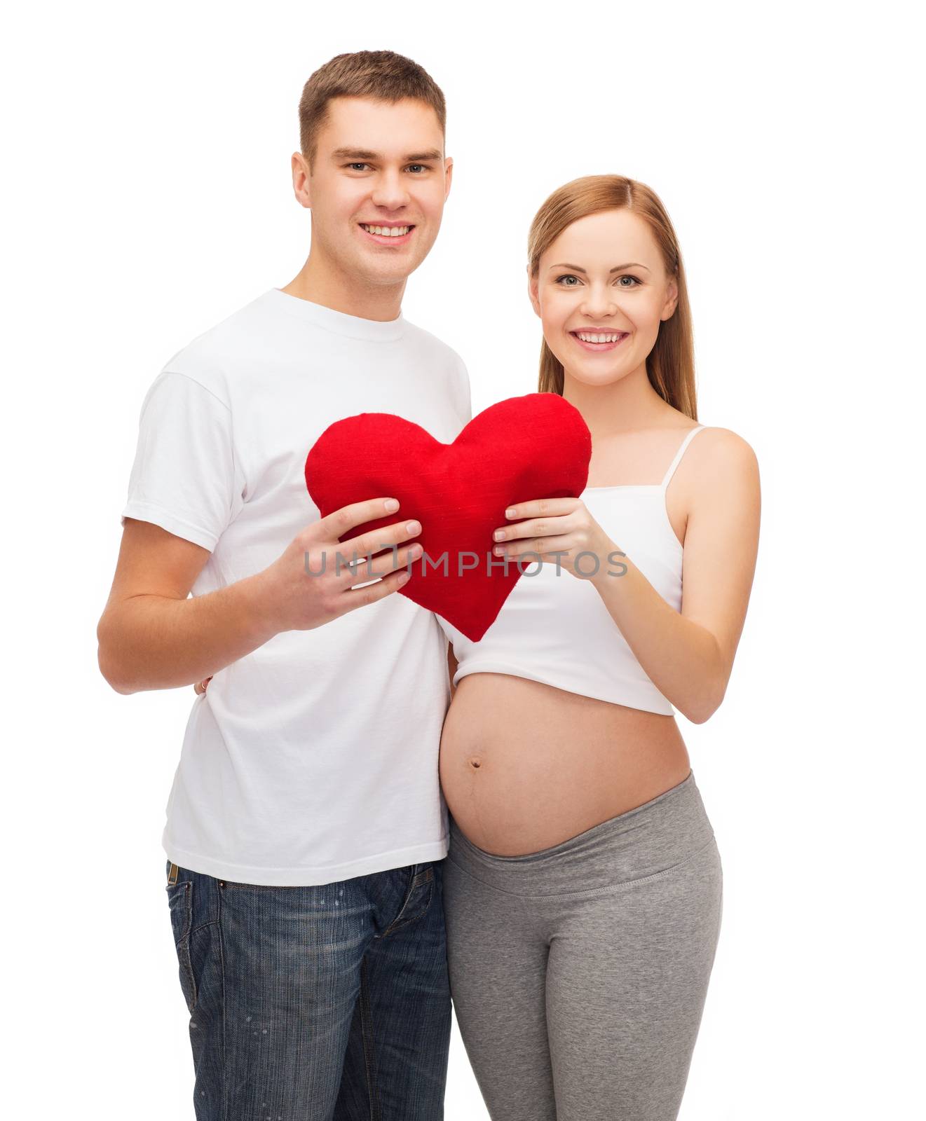 happy young family expecting child with big heart by dolgachov