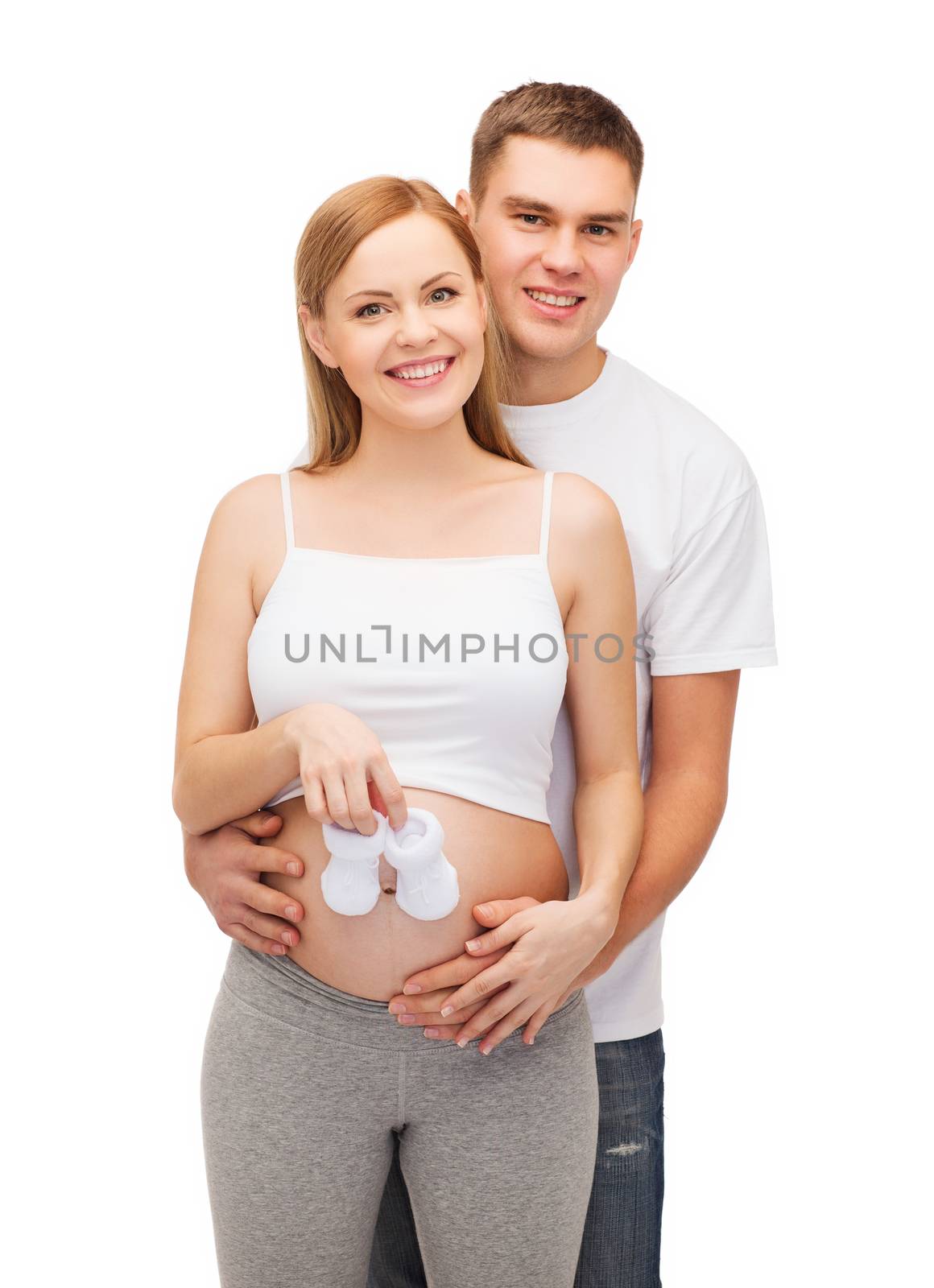 pregnancy, parenthood and happiness concept - happy young family expecting child