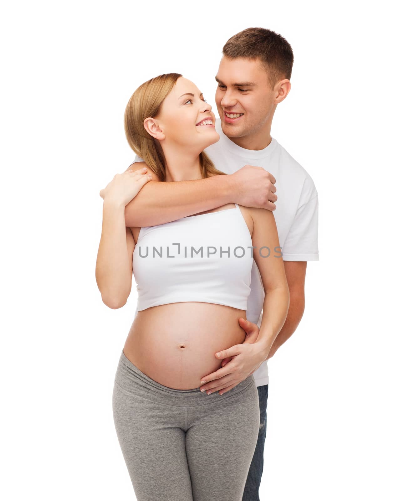 pregnancy, parenthood and happiness concept - happy young family expecting child