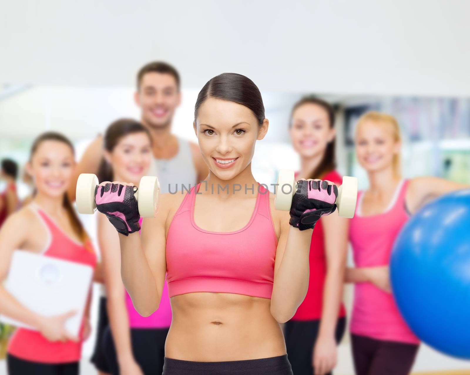 personal trainer with group in gym by dolgachov