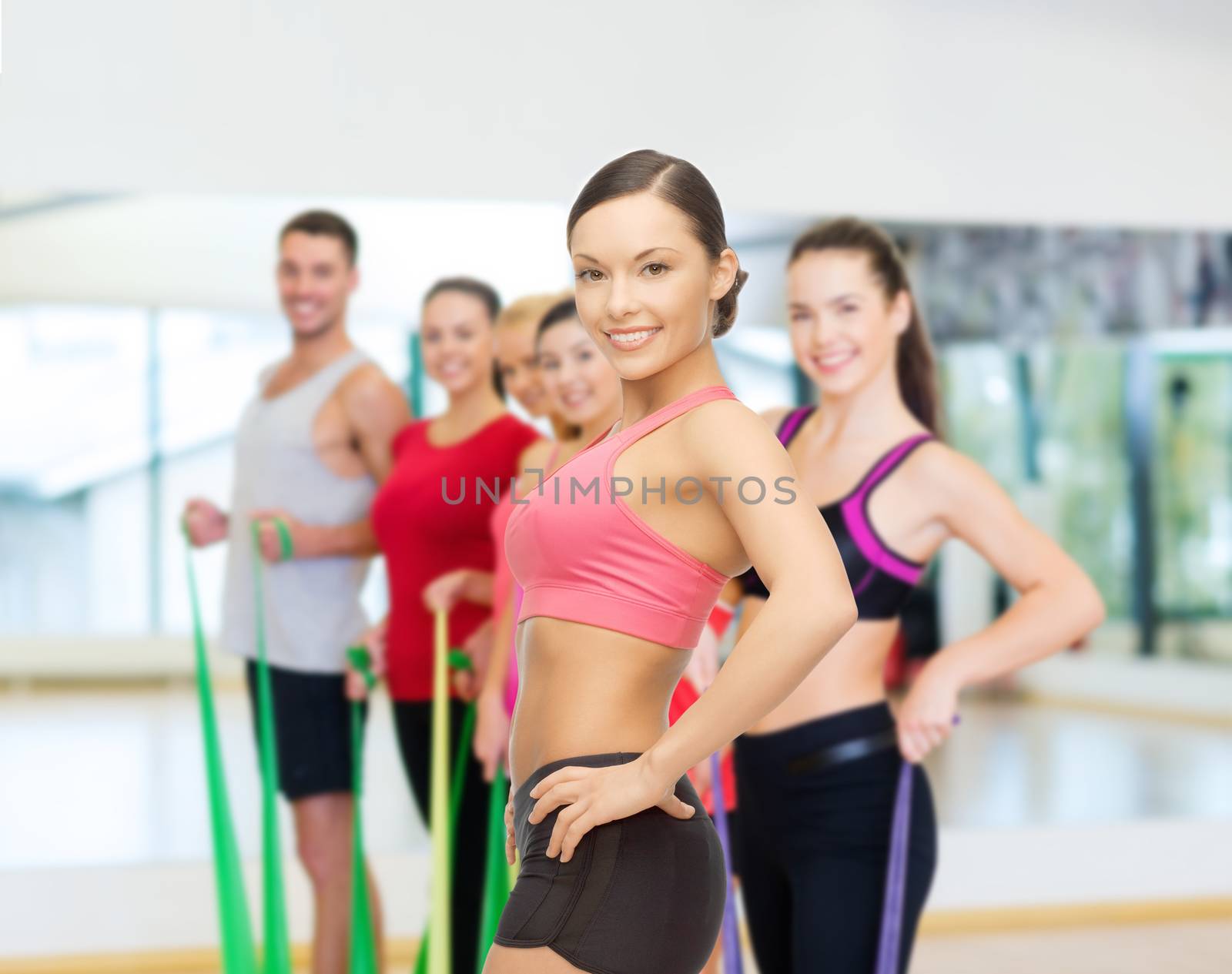 personal trainer with group in gym by dolgachov