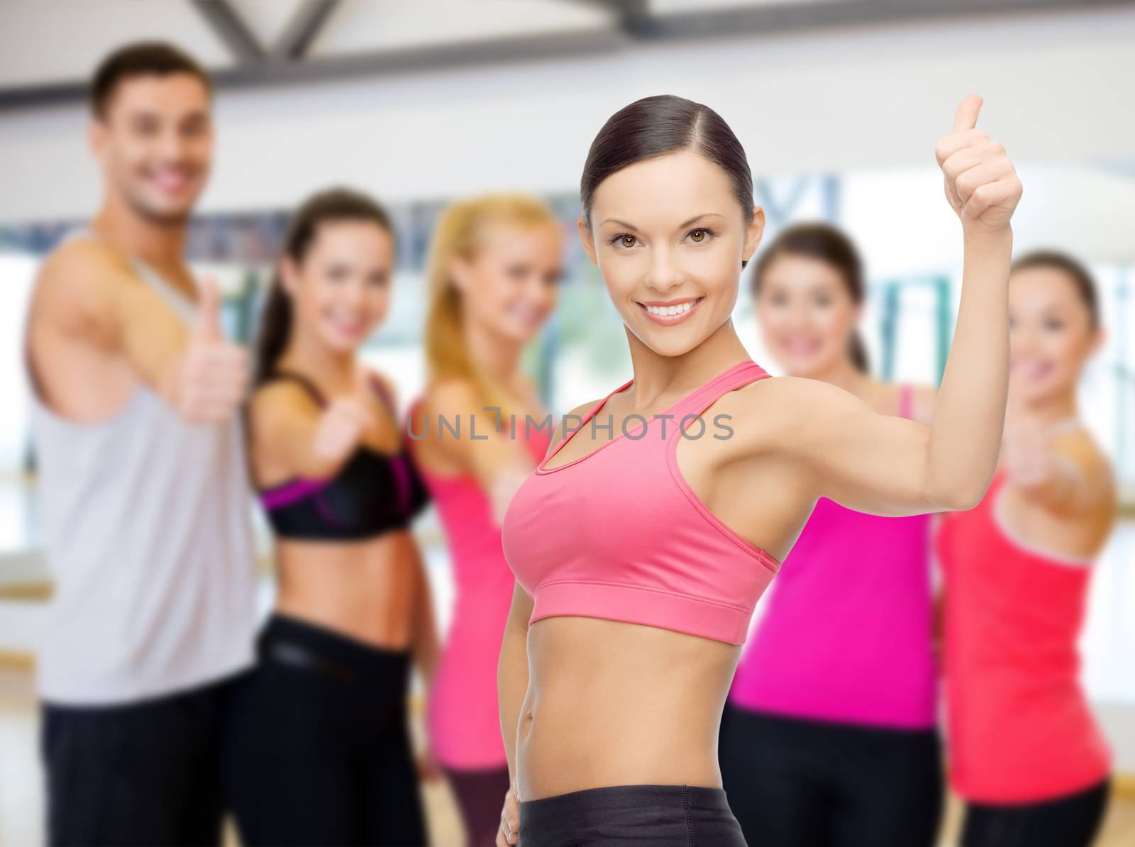 personal trainer with group in gym by dolgachov