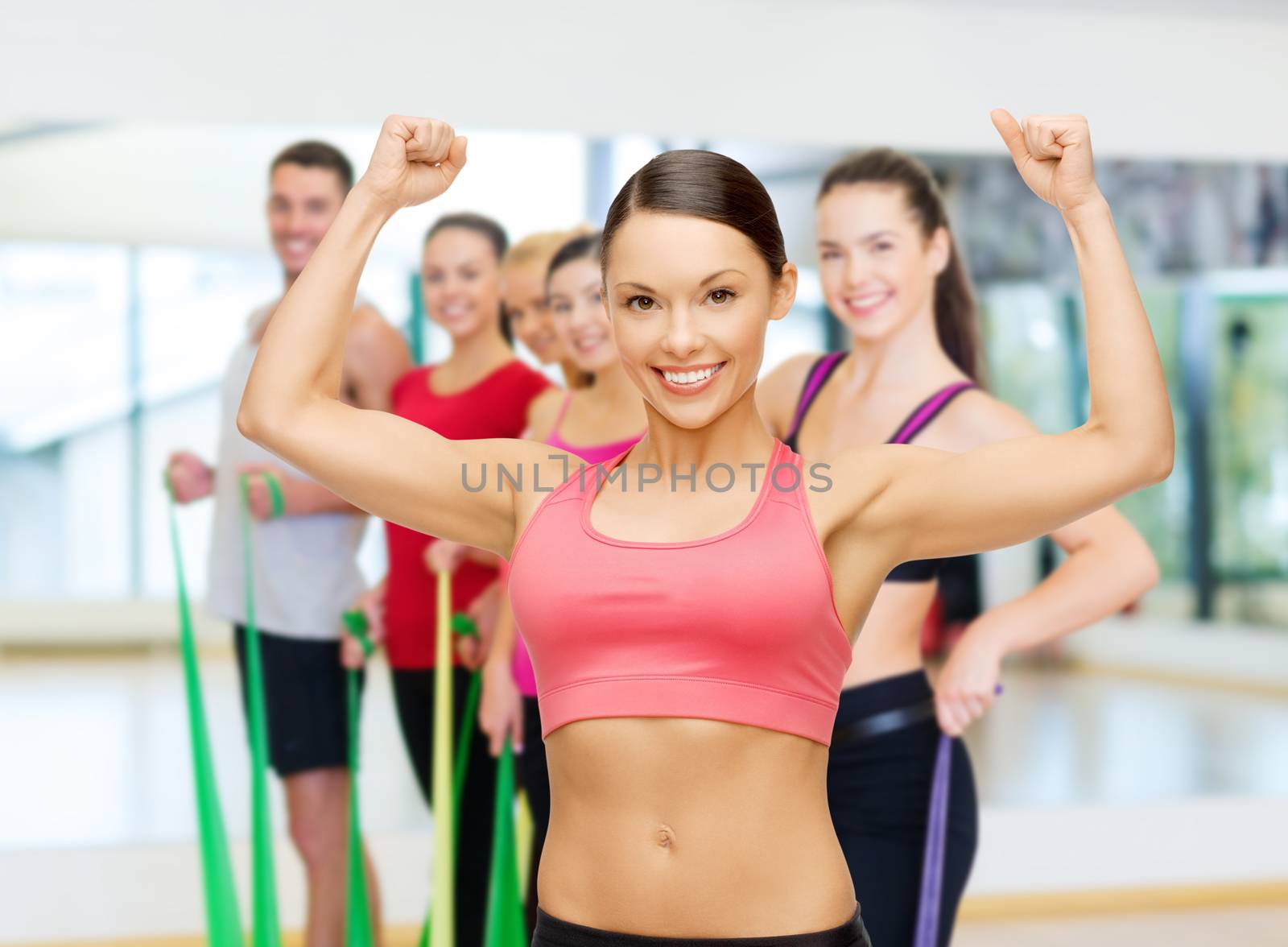 fitness, sport, training and lifestyle concept - personal trainer with group of smiling people in gym