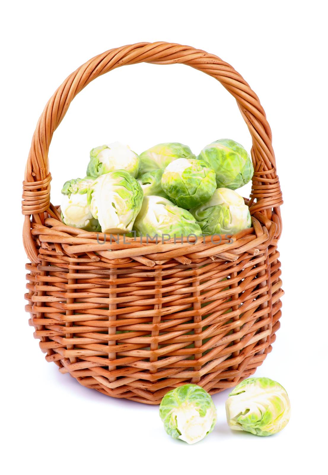 Fresh Raw Brussels Sprouts in Wicker Basket isolated on White background