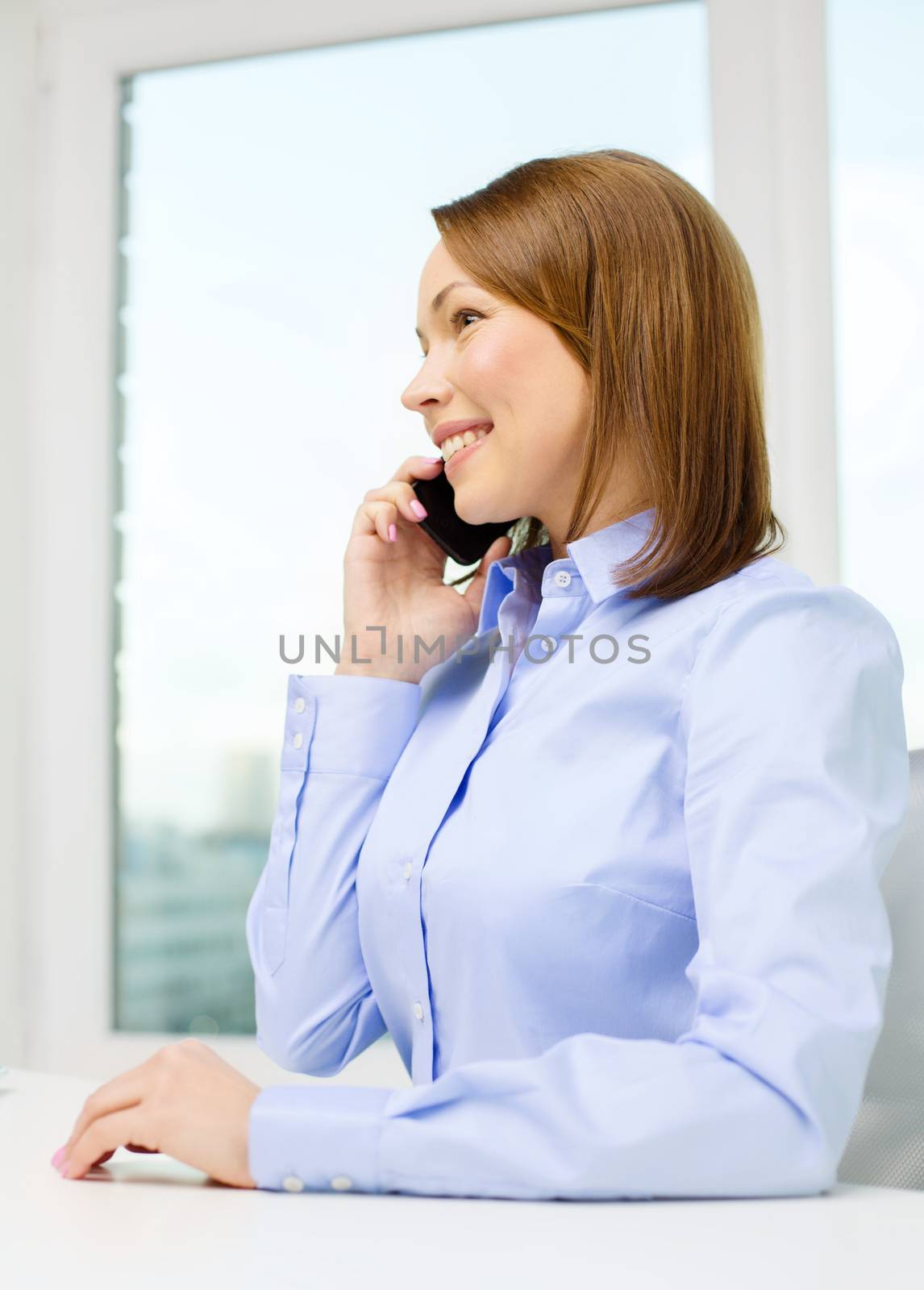 african businesswoman with smartphone in office by dolgachov