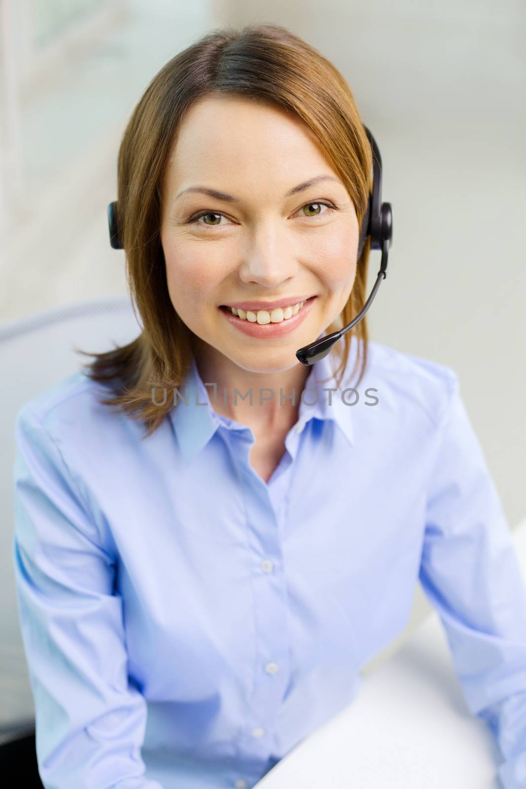 female helpline operator with headphones by dolgachov