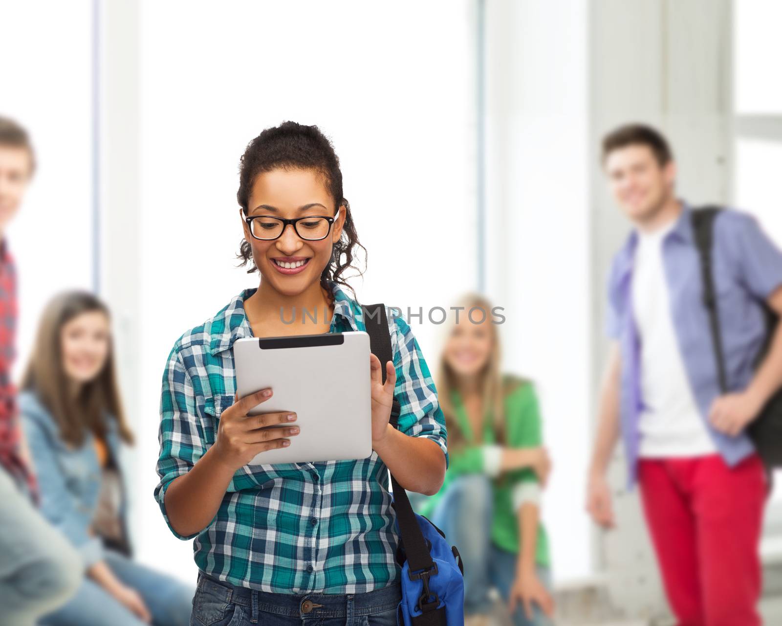 education, technology and people concept - smiling female african american student in eyeglasses with tablet pc and bag