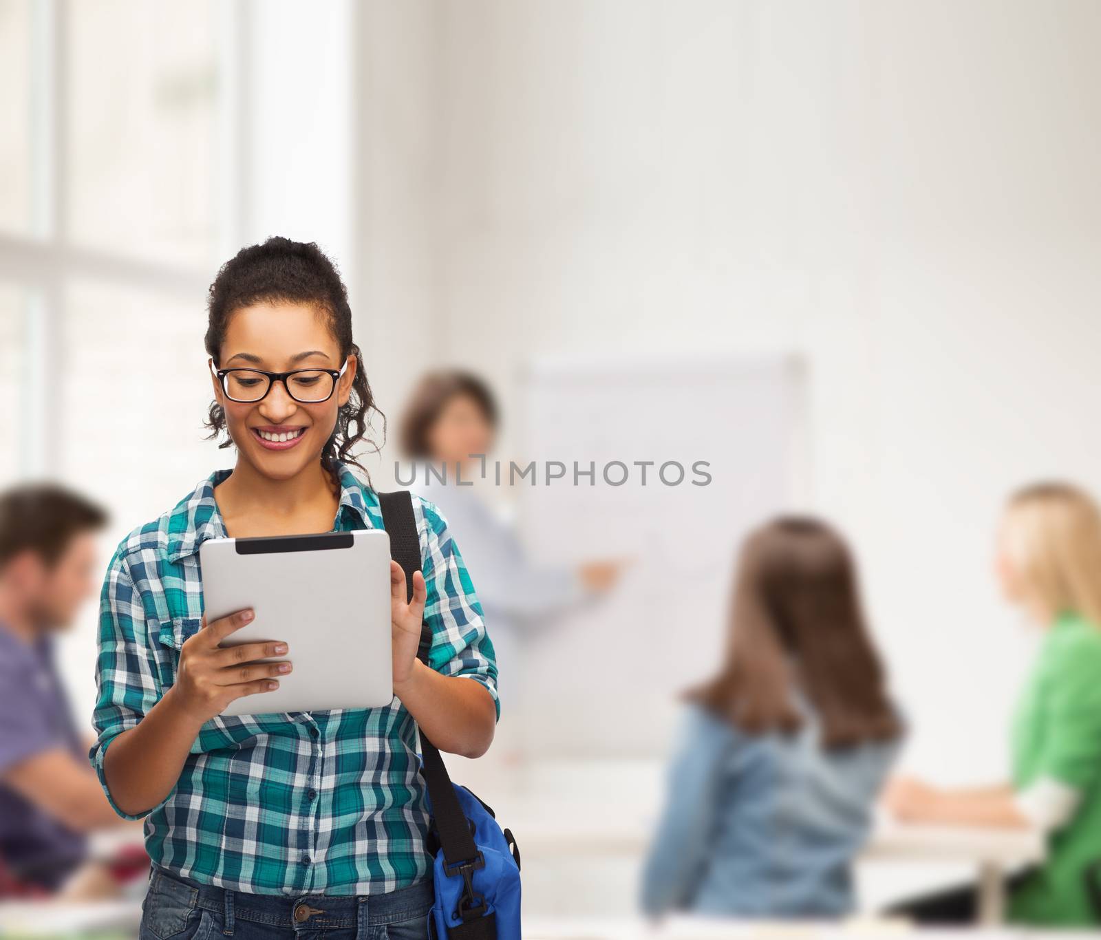 student in eyeglasses with tablet pc and bag by dolgachov