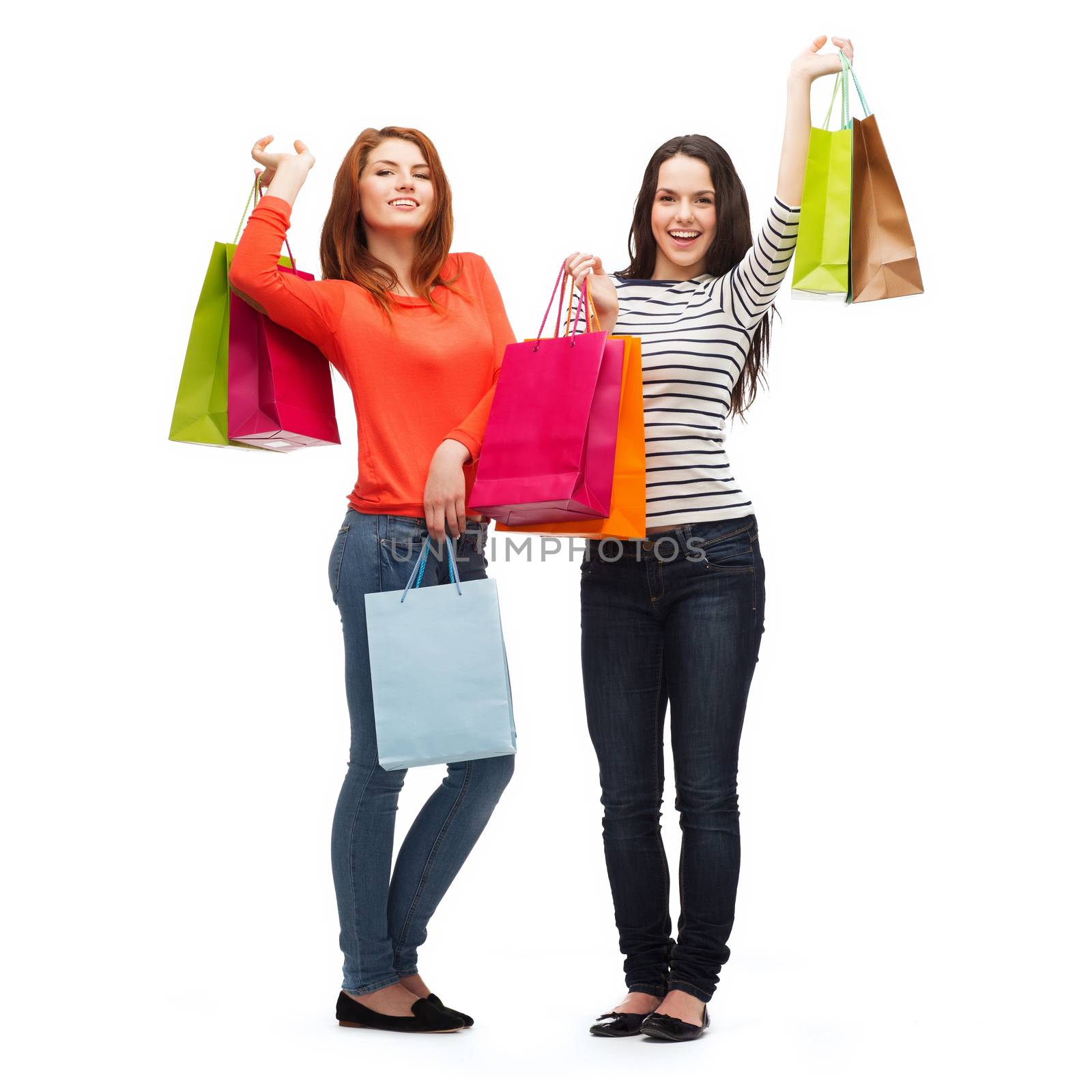 two smiling teenage girls with shopping bags by dolgachov