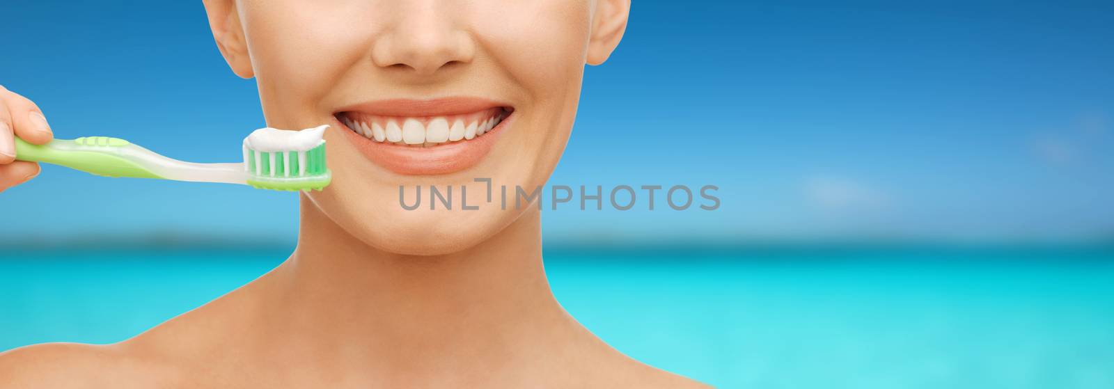 beauty and dental health concept - beautiful woman with green toothbrush