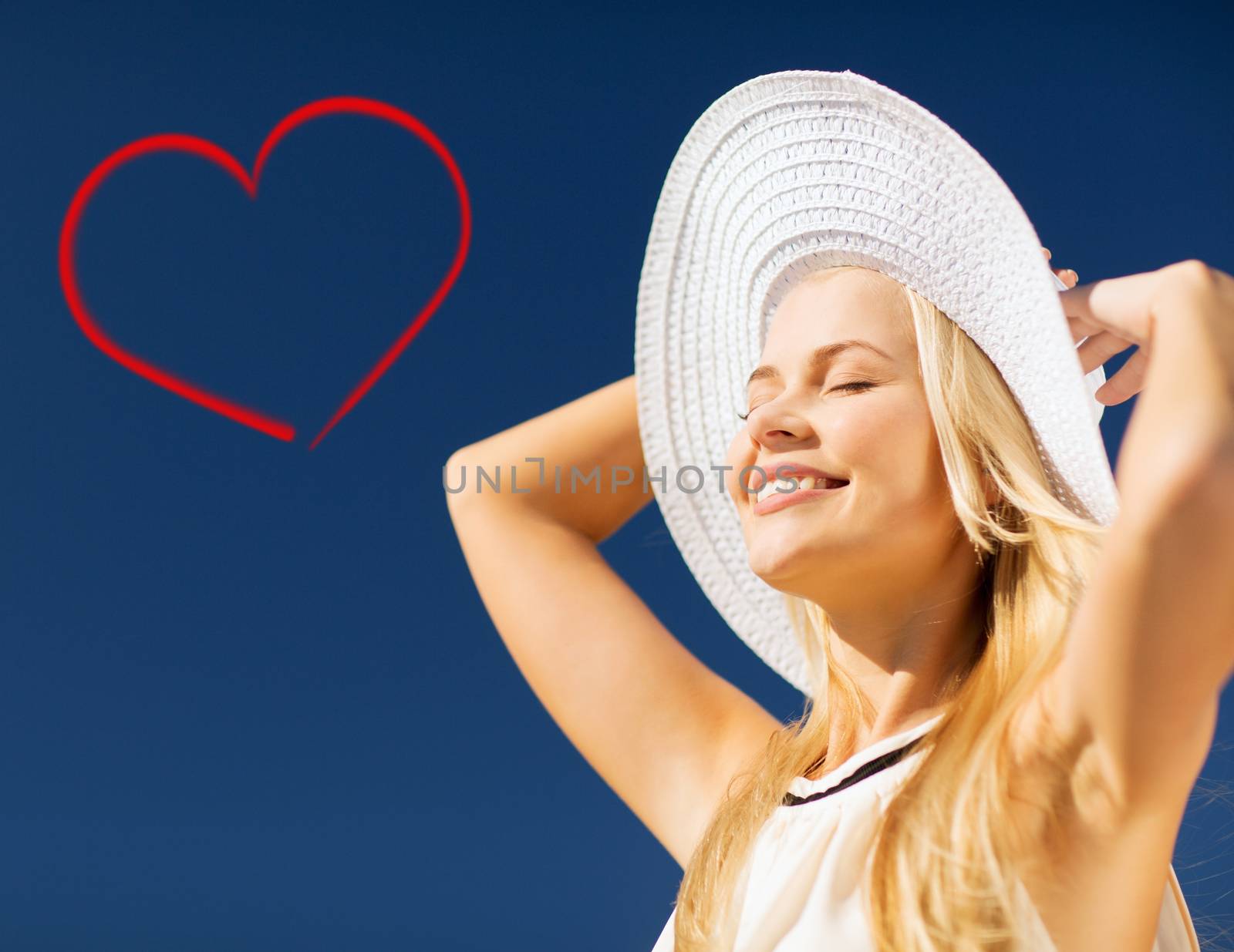 fashion and lifestyle concept - beautiful woman in hat enjoying summer outdoors