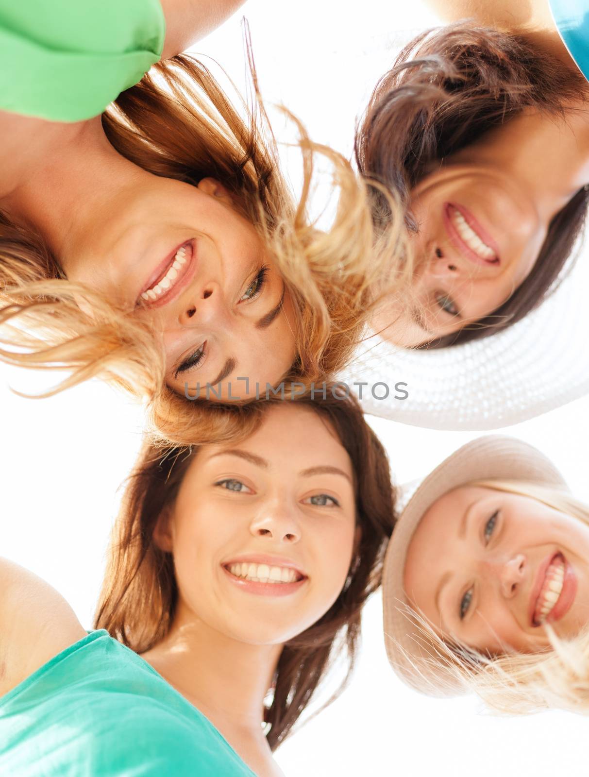 summer holidays and vacation concept - faces of girls looking down and smiling