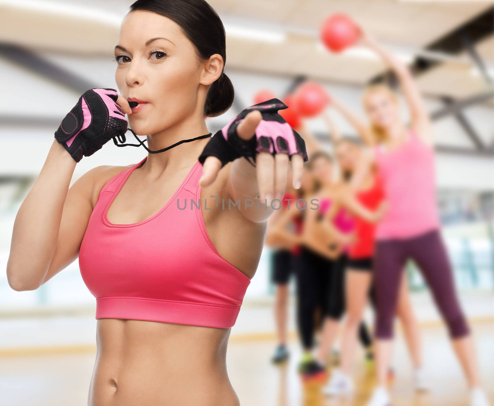 fitness, sport, training, gym and lifestyle concept - beautiful sporty woman with whistle in gym