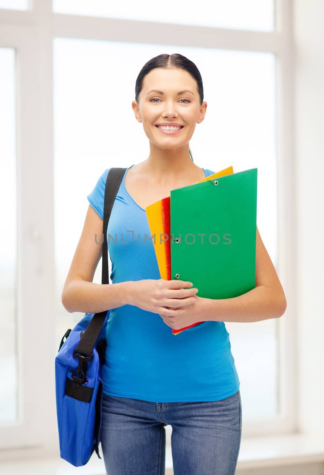 female student with folders and bag at school by dolgachov