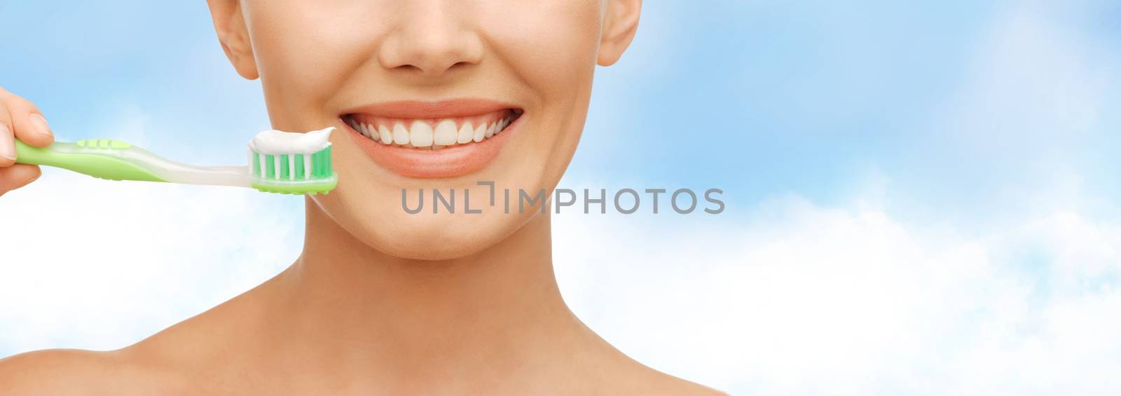 beauty and dental health concept - beautiful woman with green toothbrush