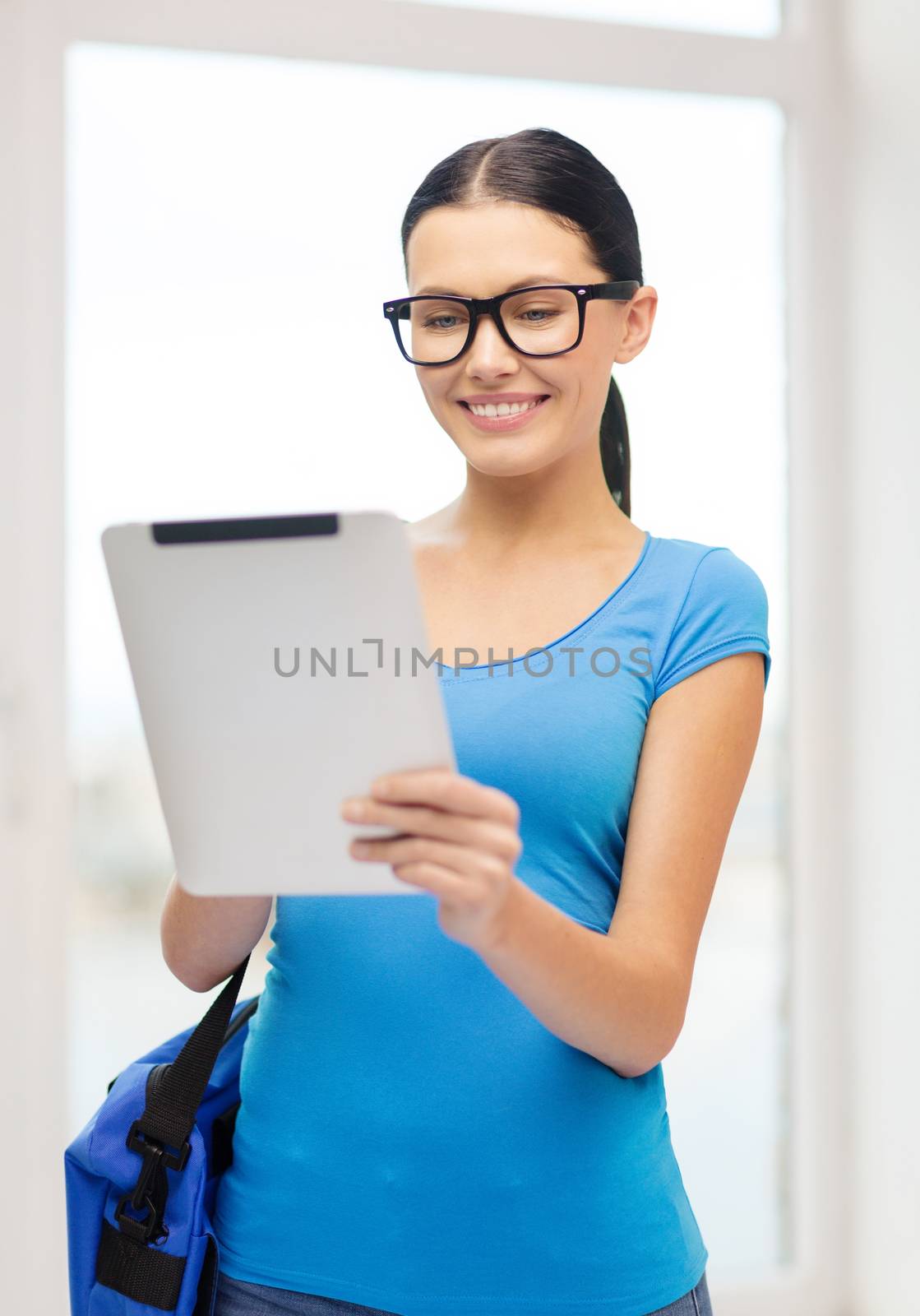 smiling female student with tablet pc and bag by dolgachov