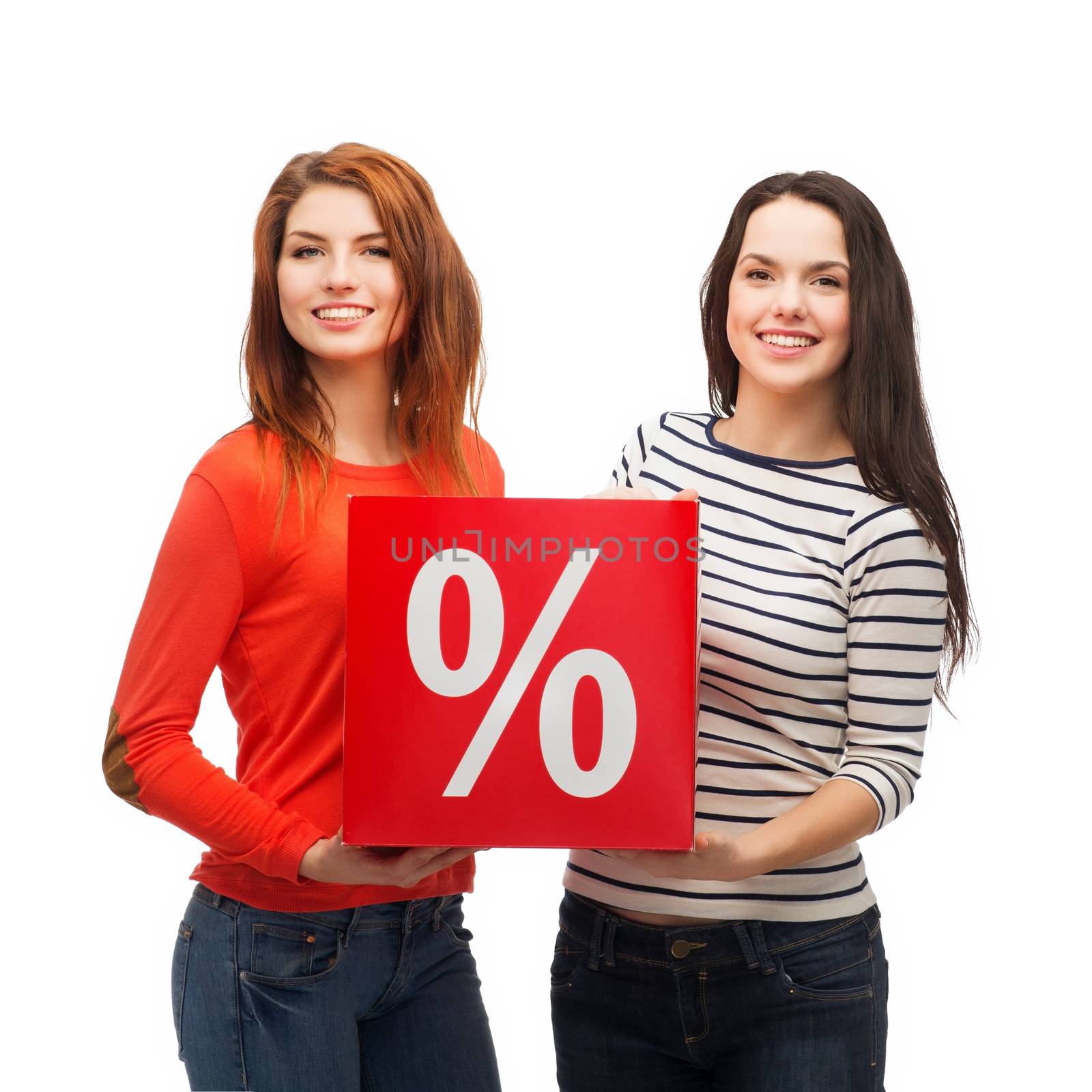 shopping, sale, and gift sconcept - two smiling teenage girls with percent sign on red box