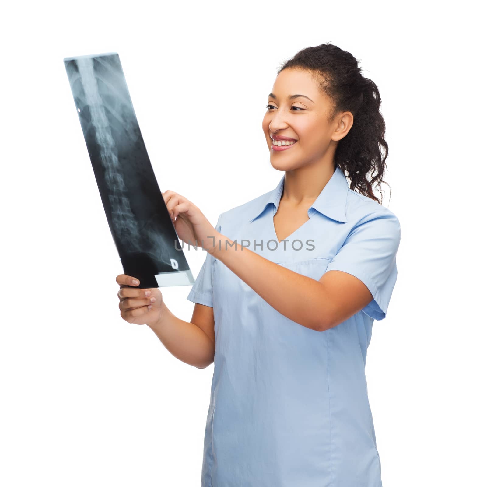 healthcare, medicine and radiology concept - smiling female african american doctor or nurse looking at x-ray