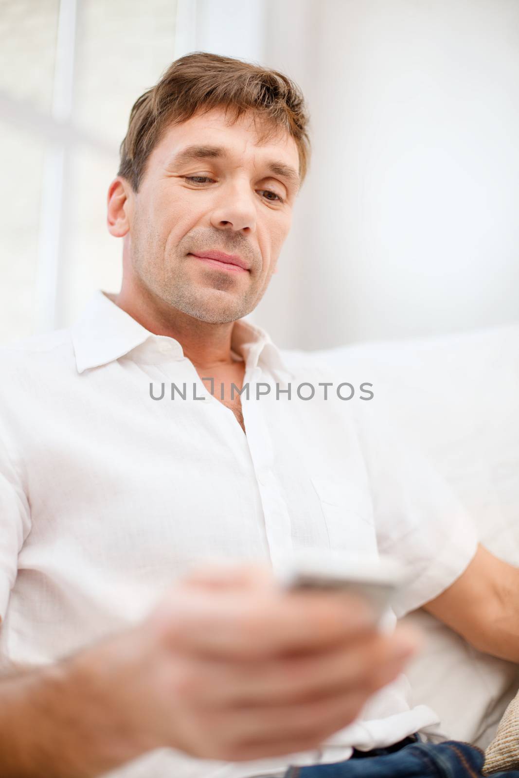 business, communication, modern technology concept - buisnessman with smartphone