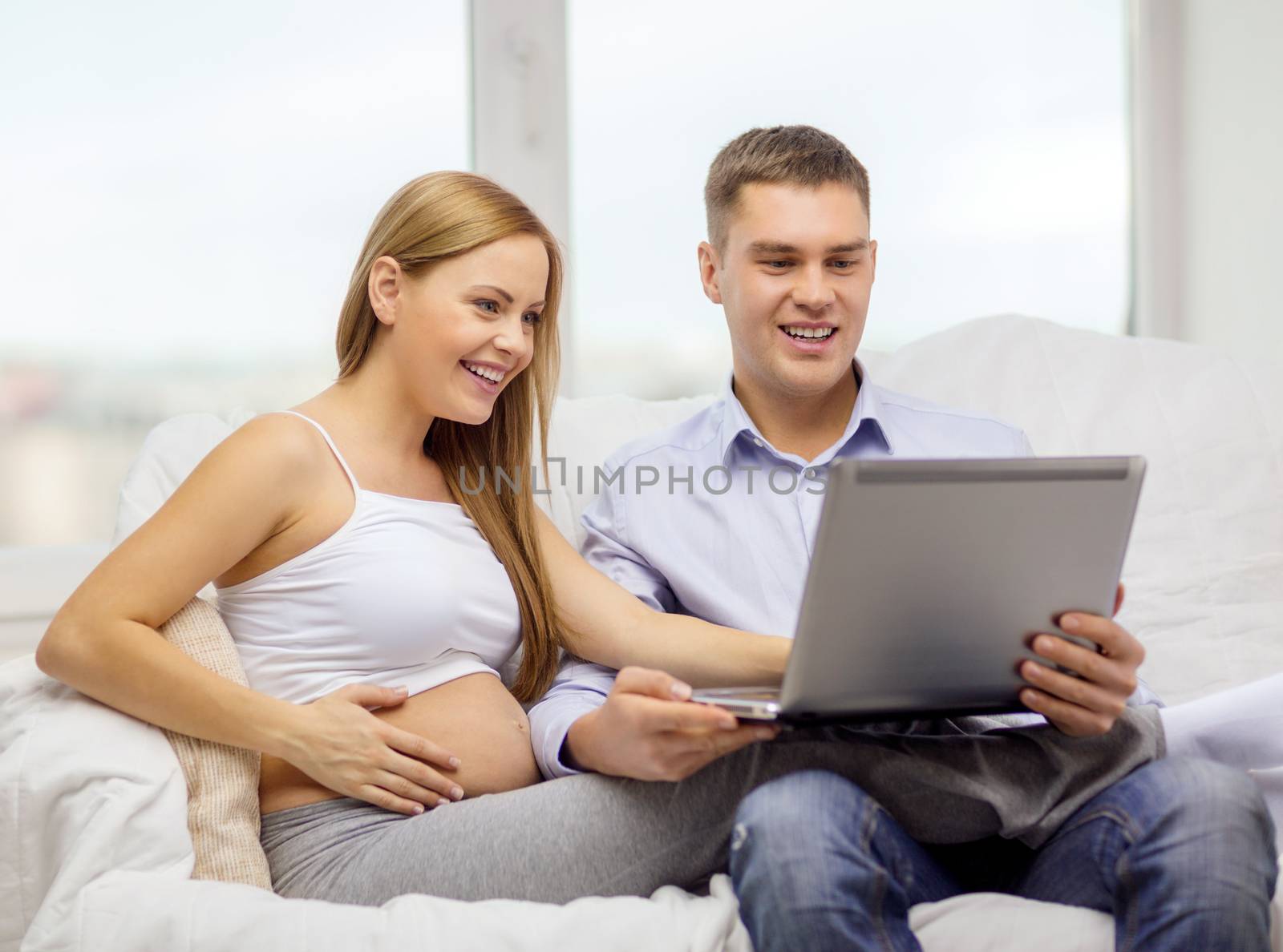 expecting family with laptop computer by dolgachov