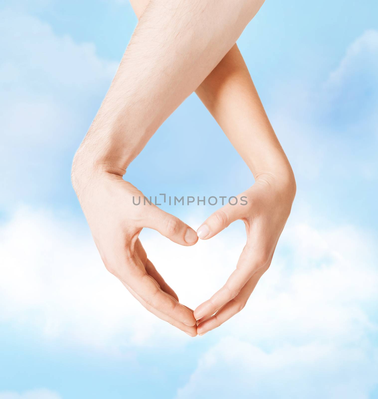 love, family and relationships concept - closeup of woman and man hands showing heart shape