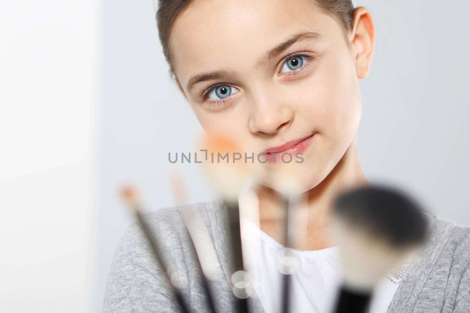 Young teenage girl with brushes for make-up by robert_przybysz