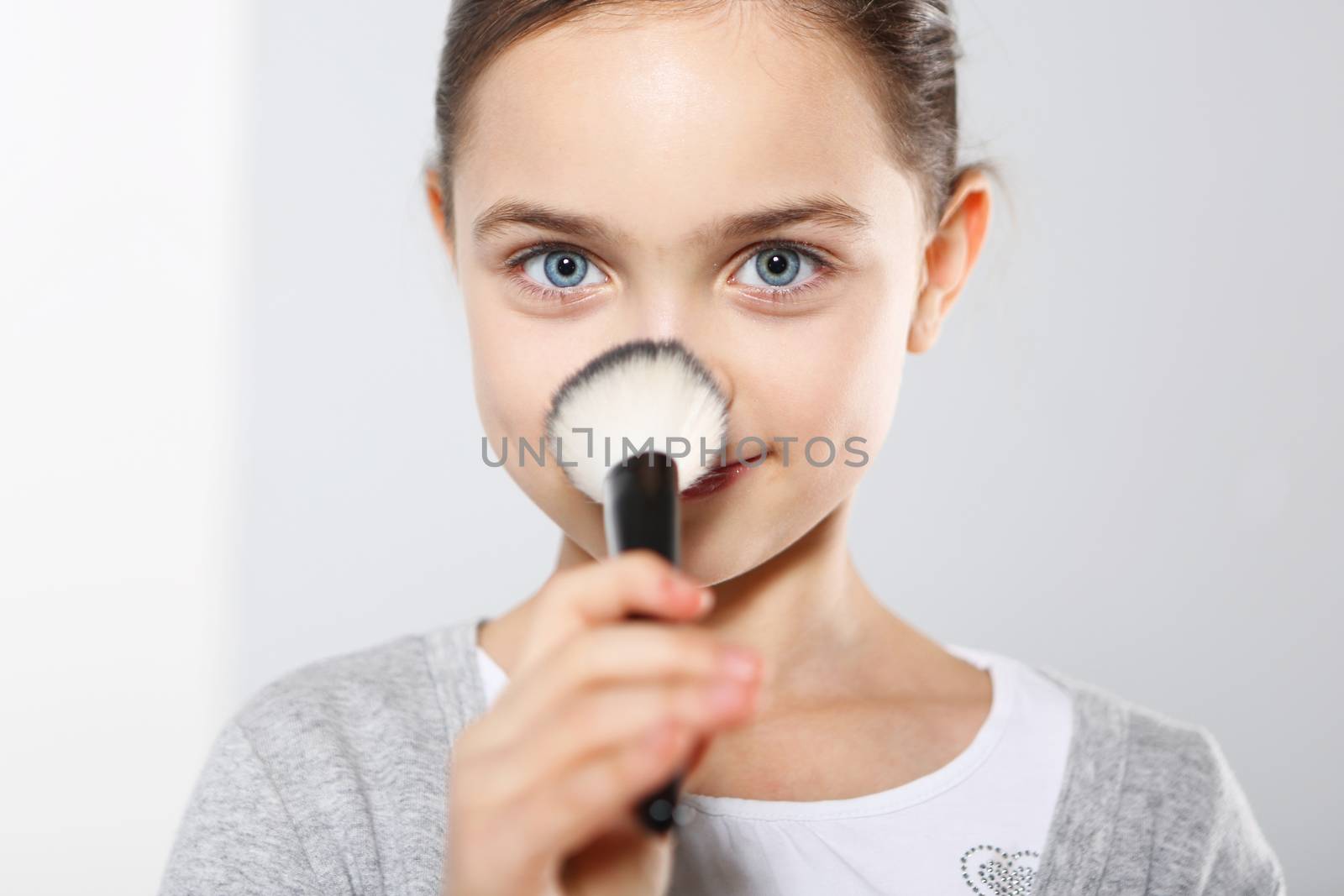 Pretty girl powdering her nose by robert_przybysz