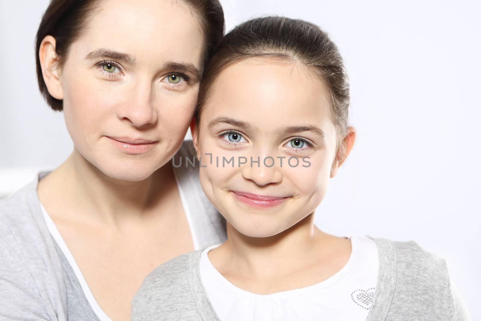Young mom with beautiful daughter isolated on white background