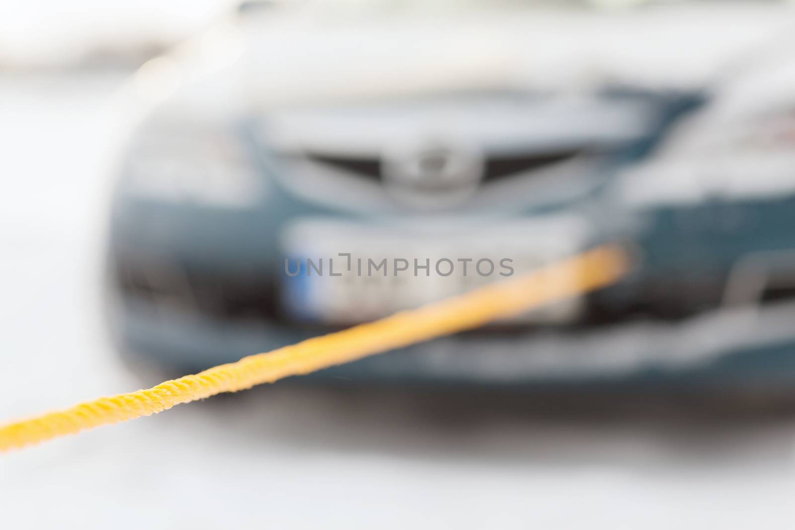 closeup of towed car with towing rope by dolgachov