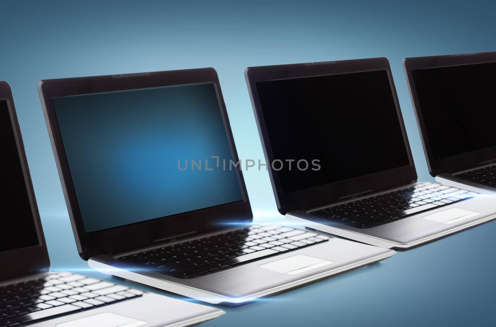 technology and advertisement concept - many laptop computers with blank black screens