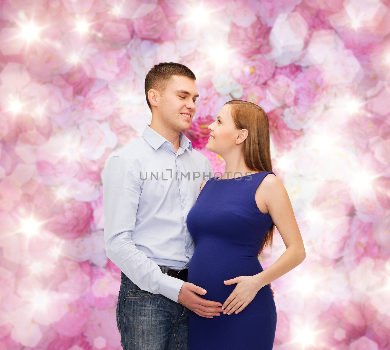 happy young family expecting child by dolgachov
