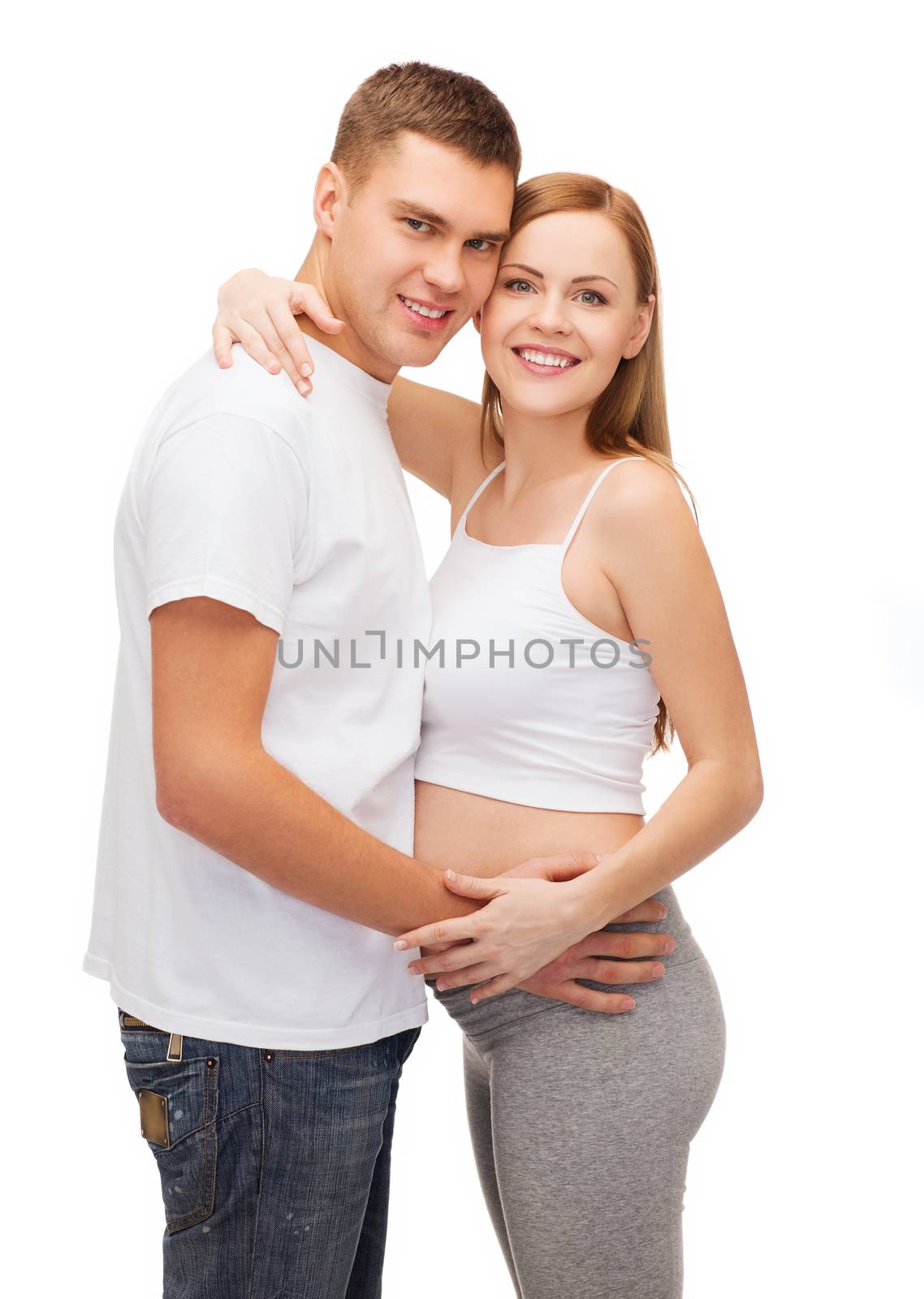 happy young family expecting child by dolgachov