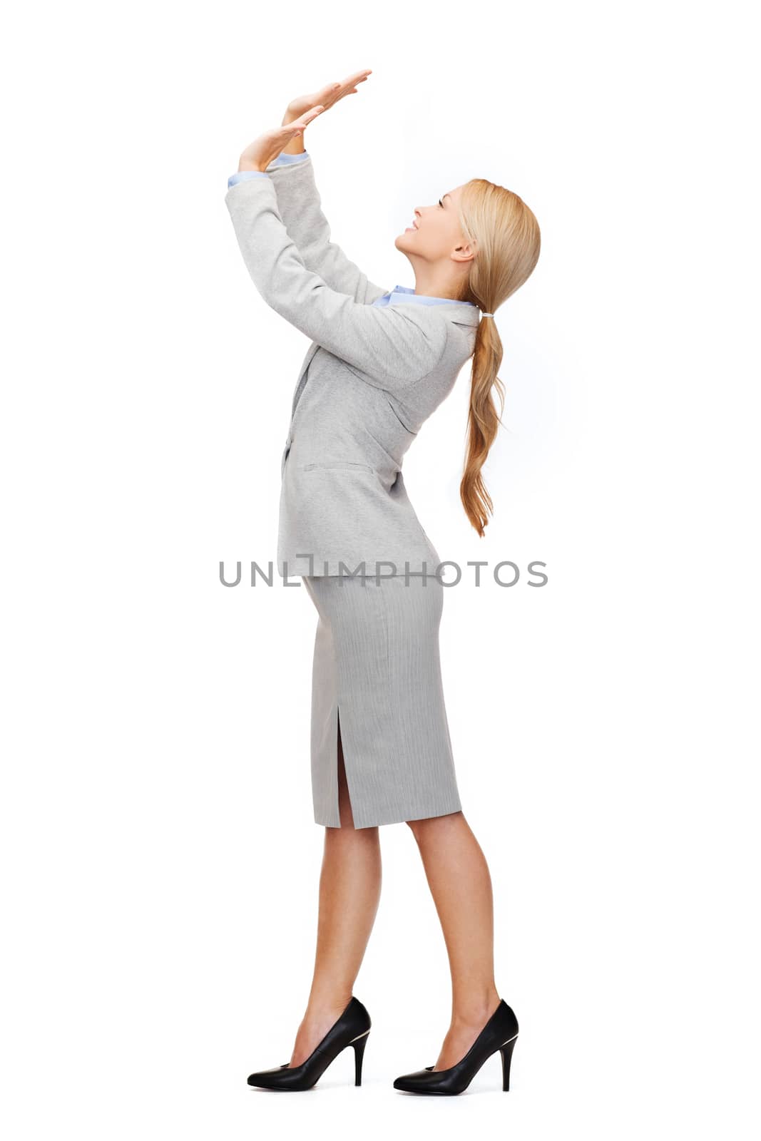 business and education concept - friendly young smiling businesswoman pushing up something imaginary