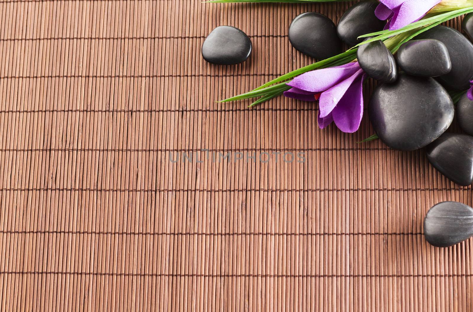 massage stones with flowers on mat by dolgachov