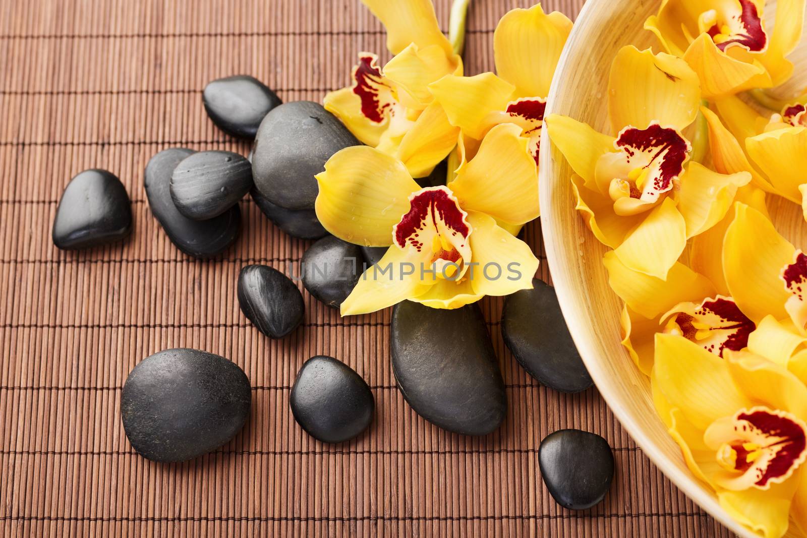 massage stones with flowers on mat by dolgachov