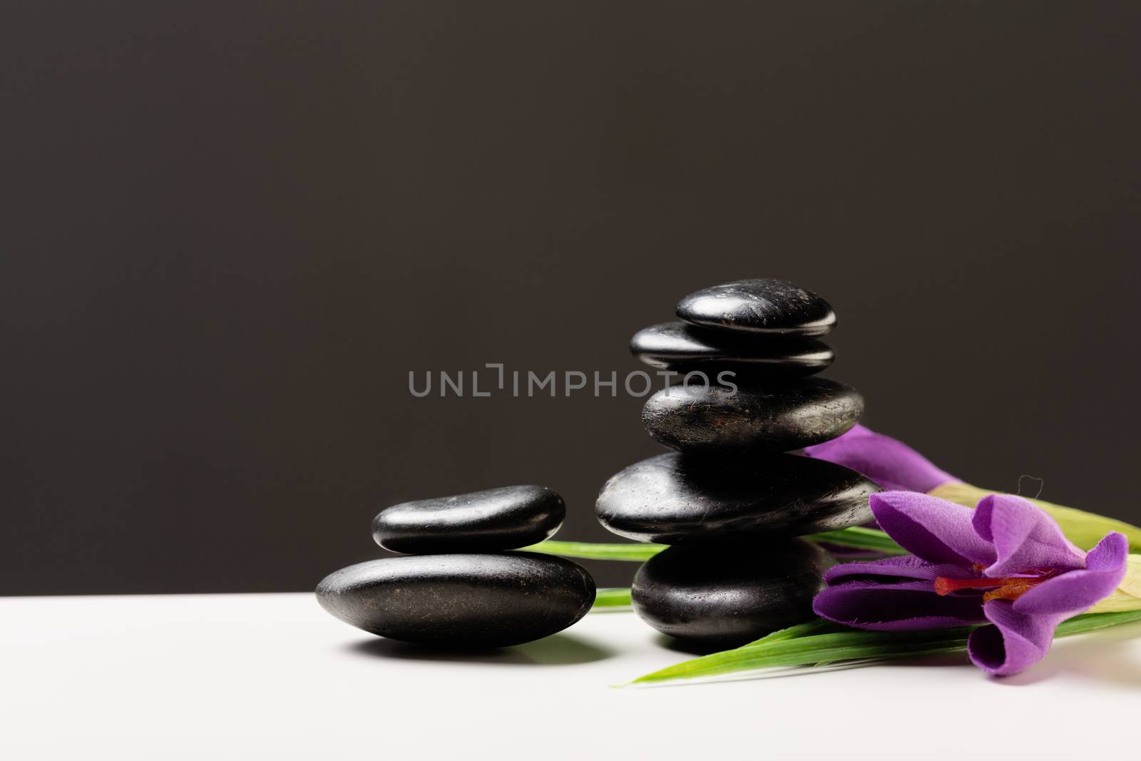 massage stones with flowers on mat by dolgachov