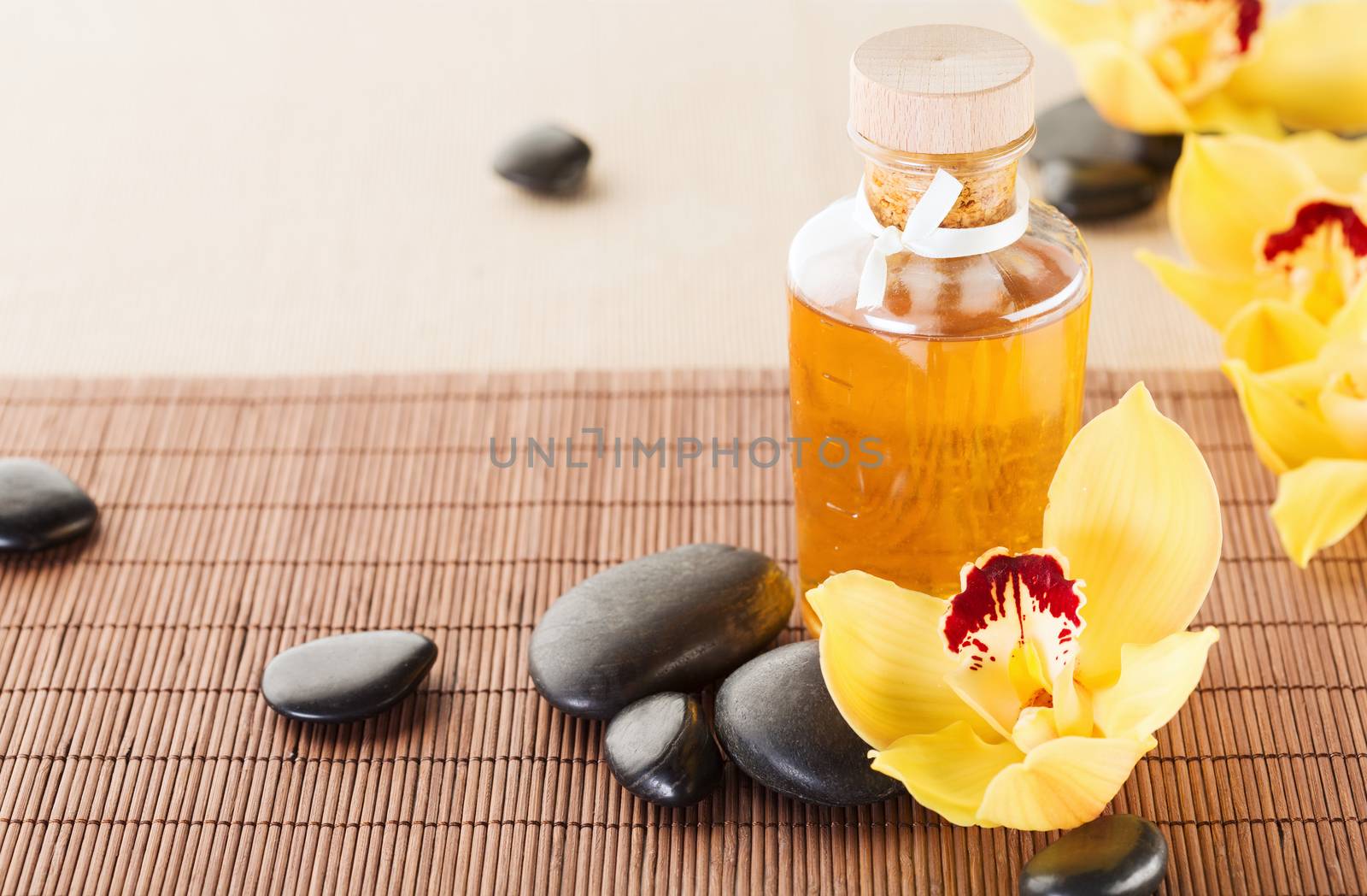 essential oil, massage stones and orchid flowers by dolgachov