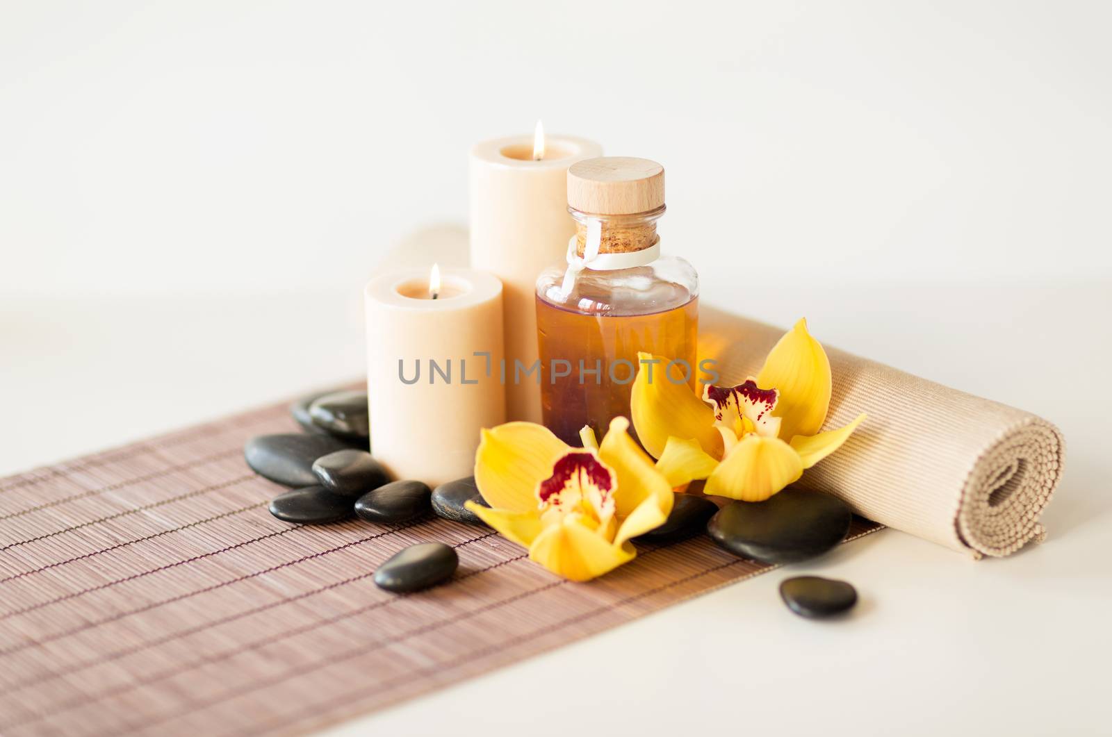 essential oil, massage stones and orchid flower by dolgachov