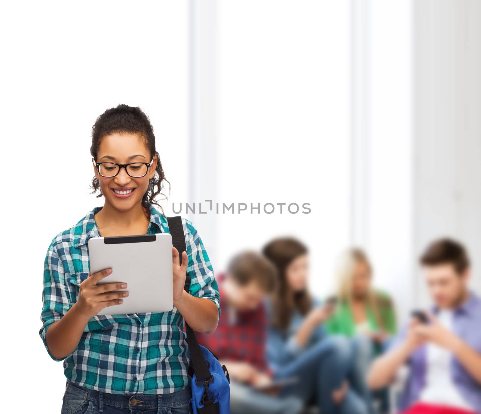 student in eyeglasses with tablet pc and bag by dolgachov